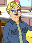 A blonde woman in a blue flannel shirt sits at her kitchen table.