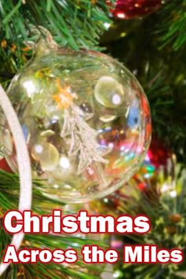 A closeup of a clear glass Christmas ball ornament on a Christmas tree. The lights from the tree reflect on its surface , and there is a little tree drawn on it. Christmas Across The Miles is written below it.
