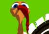 A turkey looks down at a bush covered in berries.
