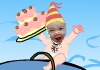 A baby riding on a whale laughs happily, and holds a birthday cake in the air.