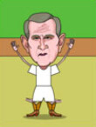 George W. Bush waves excitedly. He's wearing a white t-shirt, white shorts, and cowboy boots.