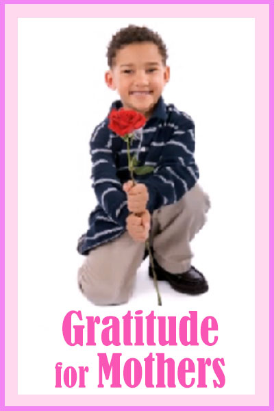 A smiling child holds a red carnation in the sample image for this touching ecard for Mothers Day.