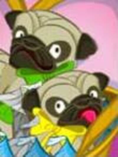Two pug puppies with bows around their necks sit in a basket surrounded by chocolate candy kisses.