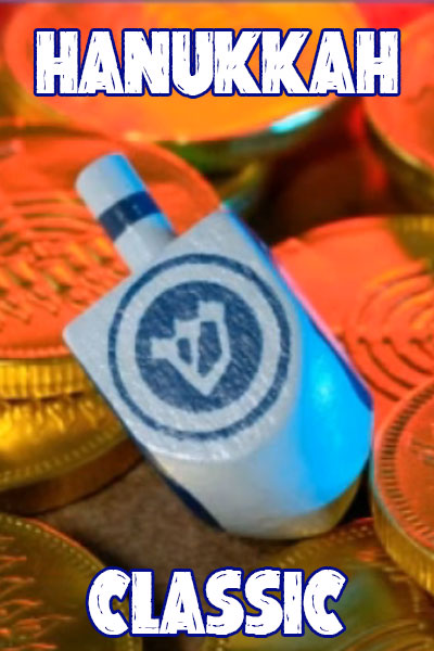 A blue and white dreidel lays among an assortment of chocolate coins.