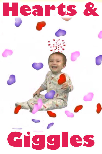 A baby giggles while colorful hearts rain down on it.
