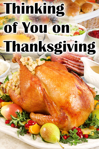 A Thanksgiving table set with a roast turkey, stuffing, and other sides.