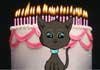 A smiling black cat with a birthday cake decorated with a line of lit candles behind it.