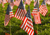 A closeup view of a field of hundreds of American flags that honor fallen soldiers.