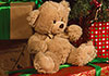 A beautifully decorated Christmas tree, with presents and toys underneath, sits next to a fireplace with stockings hung on the mantle. Christmas Comfort and Joy is written next to it.