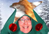 A smiling man wearing a Christmas tree costume complete with ornaments, a garland, and a star, with snow covered pine trees in the background. Christmas Tree Care is written above him.