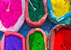 Several bags of different colored cornstarch powder. 