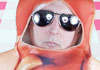 A man in a hot dog costume, and aviator sunglasses.