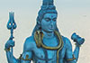 A statue of the Hindu god Shiva sits atop a column of clouds.