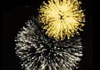 A black night sky with the words Happy New Year in sparkling gold letters and gold and silver bursts of fireworks around it.