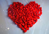 Lots of little red heart-shaped candies, formed into the shape of a heart.