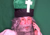 St. Patrick & the Snakes ecard's image shows Saint Patrick with long gray hair and a gray beard in a green miter and white robe. The miter has a white cross on it. The background is green.