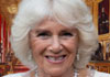 A photo of a smiling Queen Camilla.
