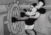 The image is taken from the very first Disney cartoon, Steamboat Willie. It shows the world's most famous cartoon mouse in black and white at the helm of a riverboat. Above him in big pink letters is the title, 